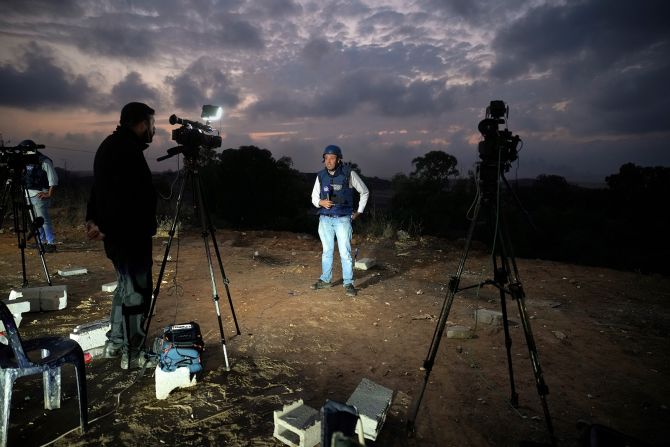 Journalists report from a vantage point overlooking northern Gaza in Sderot, Israel, on Monday, November 13.