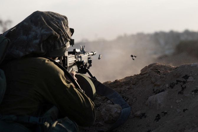 An Israeli soldier fires his weapon in Gaza on November 13.
