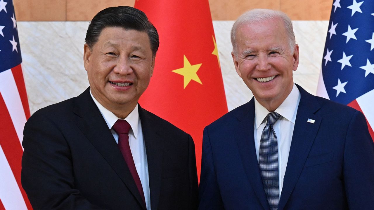 US President Joe Biden (R) and China's President Xi Jinping (L) shake hands as they meet on the sidelines of the G20 Summit in Nusa Dua on the Indonesian resort island of Bali on November 14, 2022.