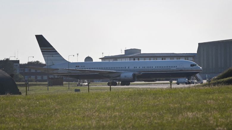 A Boeing 767 sits on the runway at the military base in Amesbury, Salisbury, on June 14, 2022, preparing to take a number of asylum-seekers to Rwanda. - The British government was to send a first plane carrying failed asylum seekers to Rwanda on Tuesday despite last-gasp legal bids and protests against the controversial policy. A chartered plane will land in Kigali on Tuesday, campaigners said, after UK judges rejected an appeal against the deportations. (Photo by JUSTIN TALLIS / AFP) (Photo by JUSTIN TALLIS/AFP via Getty Images)