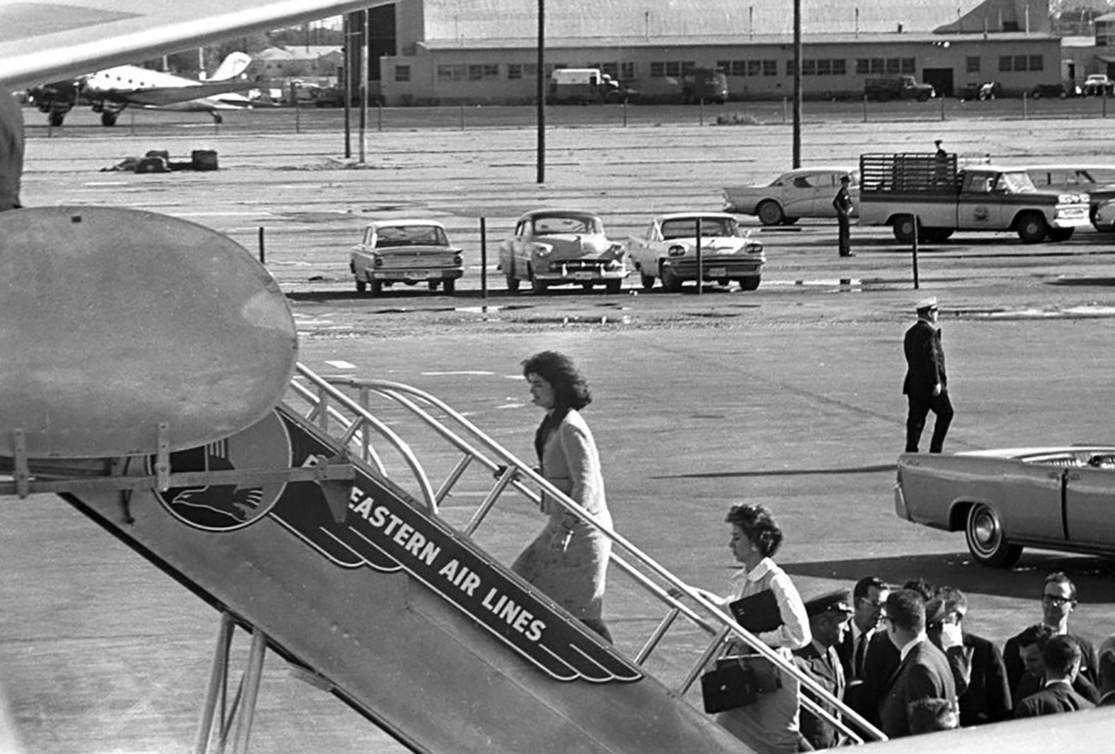 The first lady and her secretary, Mary Gallagher, board Air Force One after the transfer of Kennedy's casket to the airplane.