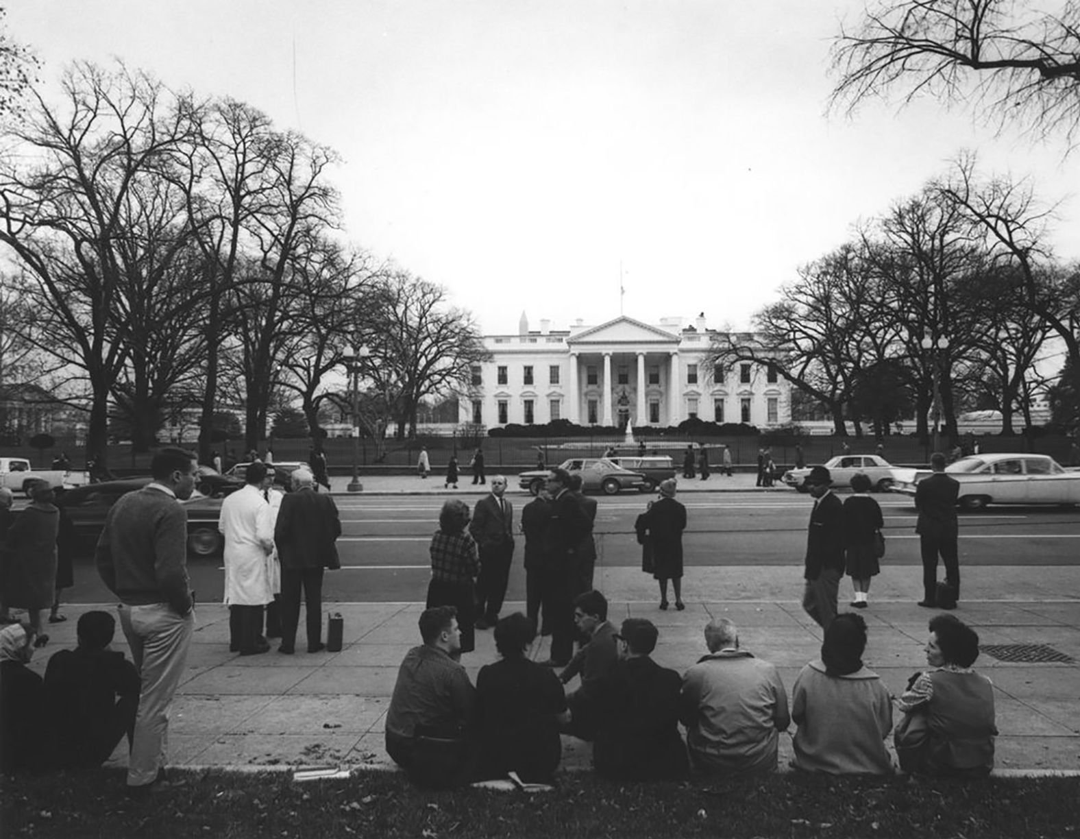 People gather on Pennsylvania Avenue in front of the White House following news of Kennedy's death.