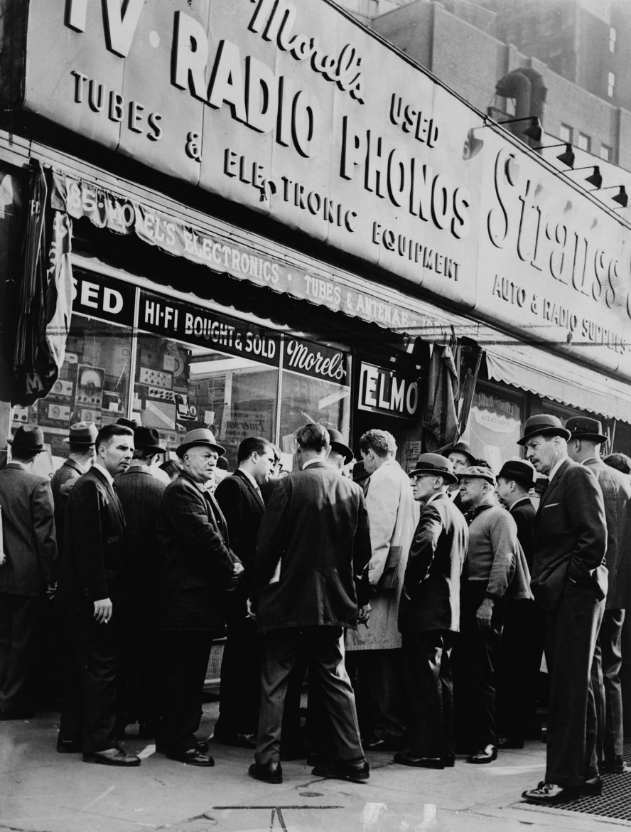 A crowd listens for Kennedy news outside a radio shop in New York City.