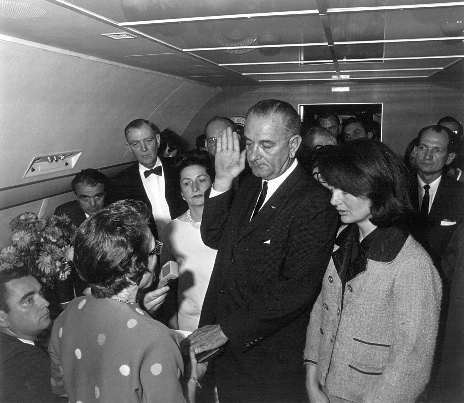 Hours after Kennedy's shooting, Johnson takes the oath of office to become the 36th president of the United States. He was aboard Air Force One as it was on the runway at Love Field. He was sworn in by US Federal Judge Sarah T. Hughes, left, with Jacqueline Kennedy by his side.
