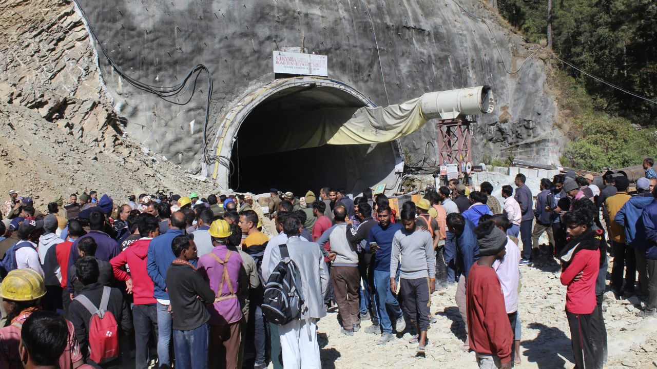 People watch rescue and relief operations at the site of an under-construction road tunnel that collapsed in mountainous Uttarakhand state, India, Wednesday, Nov. 15, 2023. Rescuers have been trying to drill wide pipes through excavated rubble to create a passage to free 40 construction workers trapped since Sunday. A landslide Sunday caused a portion of the 4.5-kilometer (2.7-mile) tunnel to collapse about 200 meters (500 feet) from the entrance. It is a hilly tract of land, prone to landslide and subsidence. (AP Photo)