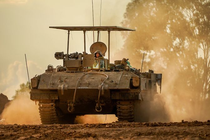An Israeli army armored fighting vehicle returns to a staging area from the border with Gaza on November 15, in southern Israel.