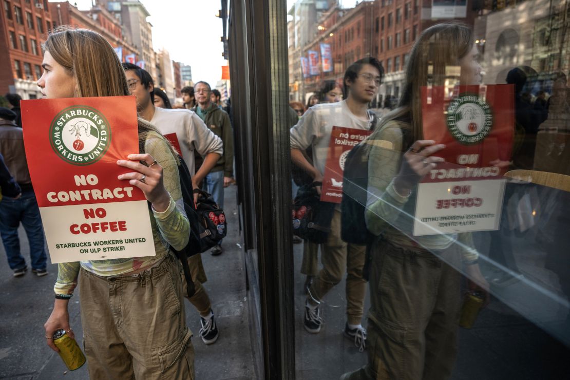 Starbucks Workers United union members and supporters on a picket line outside a Starbucks coffee shop in New York, US, on Thursday, Nov. 16, 2023. Thousands of Starbucks Corp. baristas went on strike Thursday, claiming the coffee chain refuses to fairly negotiate with their union.