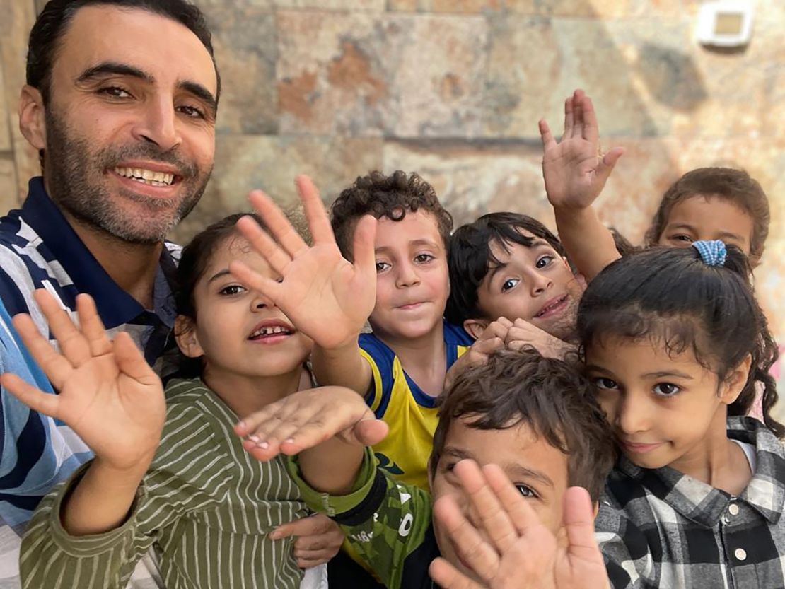 Hazem and a group of the children outside their new shelter- many holding their thumbs up (November 9)- sent by Hazem Al-Naizi.jpeg