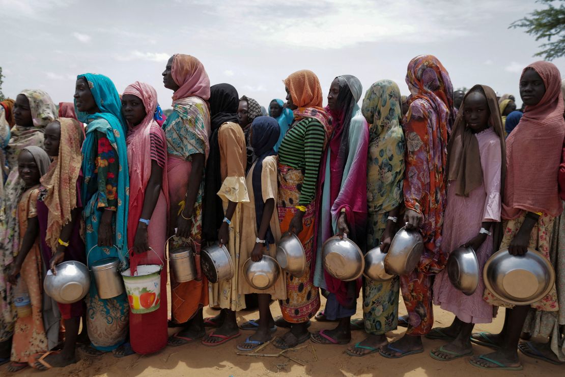 FILE PHOTO: Sudanese women who fled the conflict in Geneina in Sudan's Darfur region, line up to receive rice portions from Red Cross volunteers in Ourang on the outskirts of Adre, Chad July 25, 2023. REUTERS/Zohra Bensemra/File Photo