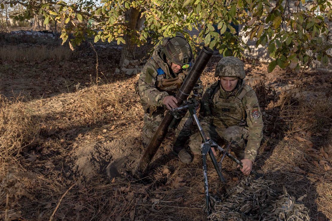 Ukrainian servicemen of the 123rd Territorial Defense Brigade prepare to fire a mortar over the Dnipro River toward Russian positions, in an undisclosed location in the Kherson region, on November 6, 2023, amid the Russian invasion of Ukraine. While Ukraine's recapture of Kherson city last November was a shock defeat for the Kremlin, Russian forces on the opposing bank still control swathes of territory and shell towns and villages they retreated from. The Dnipro, Europe's fourth-longest river and a historic trading route, has become a key front since Ukrainian troops pushed Russian forces back over its banks in the south last year. (Photo by Roman PILIPEY / AFP) (Photo by ROMAN PILIPEY/AFP via Getty Images)