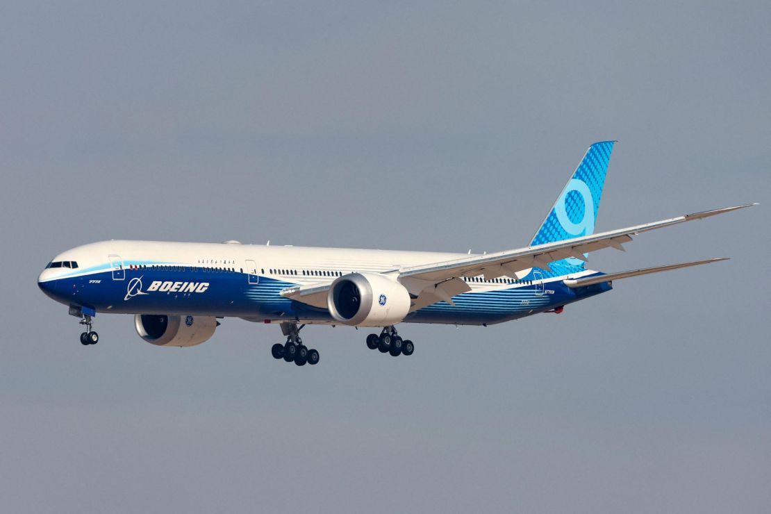 A Boeing 777-X aircraft flying at the Dubai Airshow.