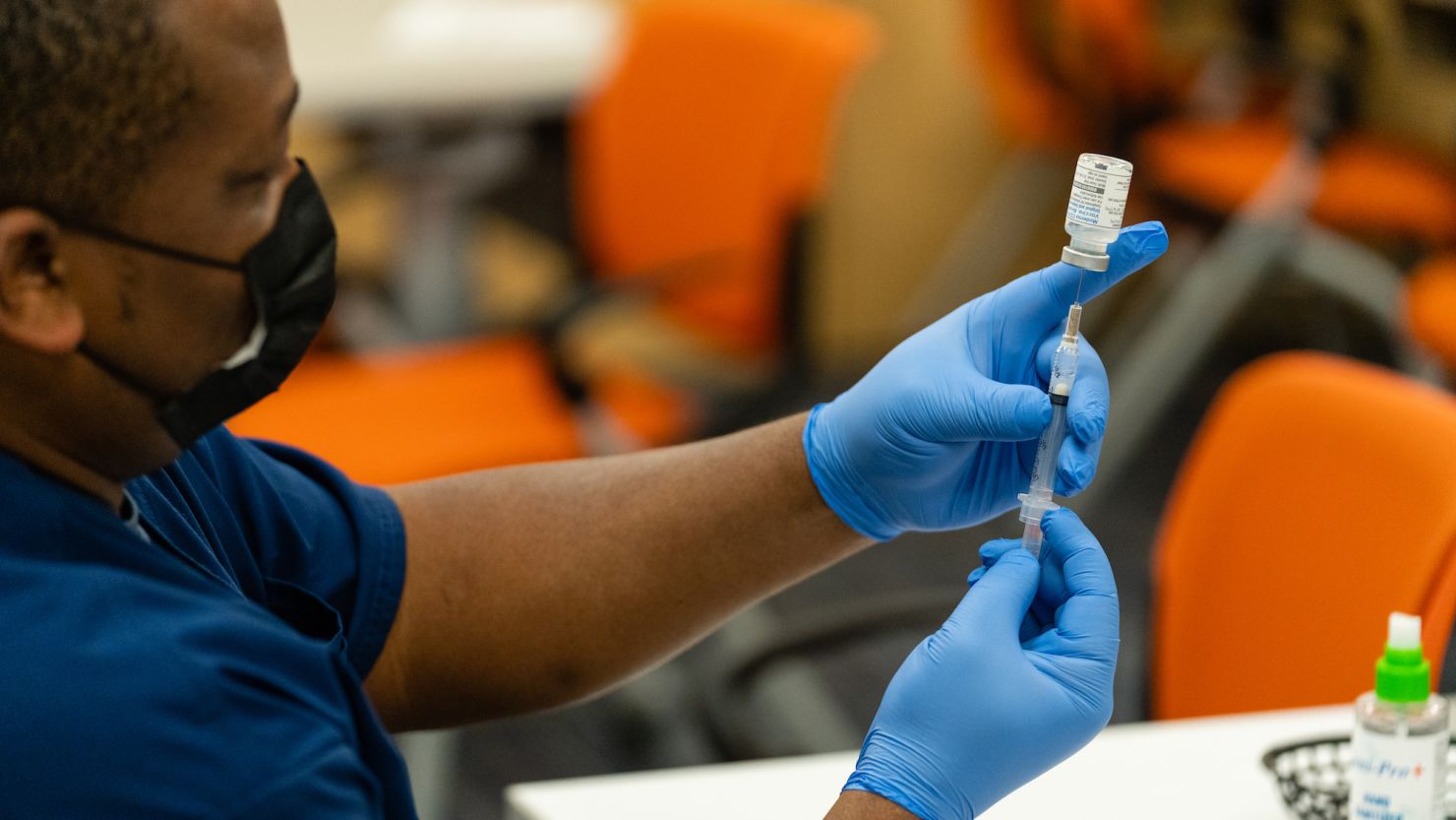 SILVER SPRING, MARYLAND - NOVEMBER 21: A healthcare employee prepares a syringe with the Moderna COVID-19 vaccine at the Dennis Avenue Health Center in Silver Spring, Maryland on November 21, 2022. While COVID-19 remains a serious concern for this holiday season, this year two other common respiratory viruses, influenza and RSV, are wreaking havoc  particularly in the D.C. area, which is one of the regions with the highest flu activity in the country. (Eric Lee for The Washington Post via Getty Images)