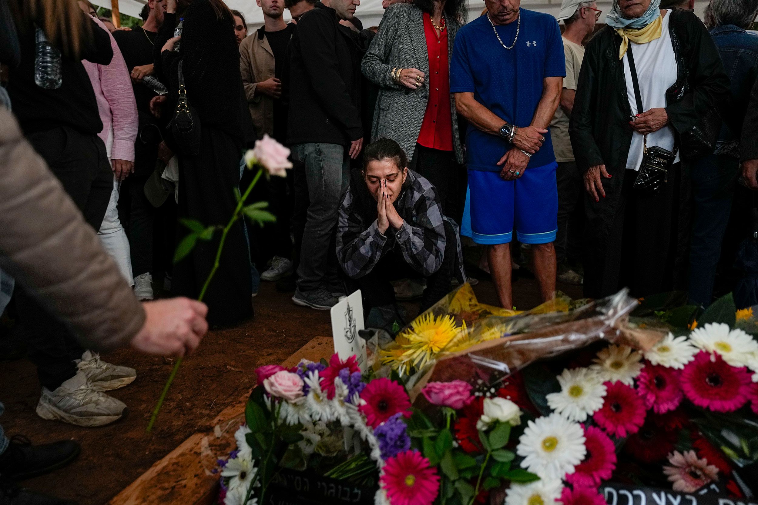 Mourners gather around the grave of Israeli reserve soldier Master Sgt. Raz Abulafia at the end of his funeral in Rishpon, Israel, on Tuesday, November 14.