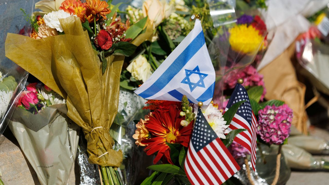 Flowers and flags are placed at the exact location on the sidewalk of the alleged assault on Paul Kessler on Sunday in Thousand Oaks, California, U.S., November 7, 2023.   REUTERS/Mike Blake