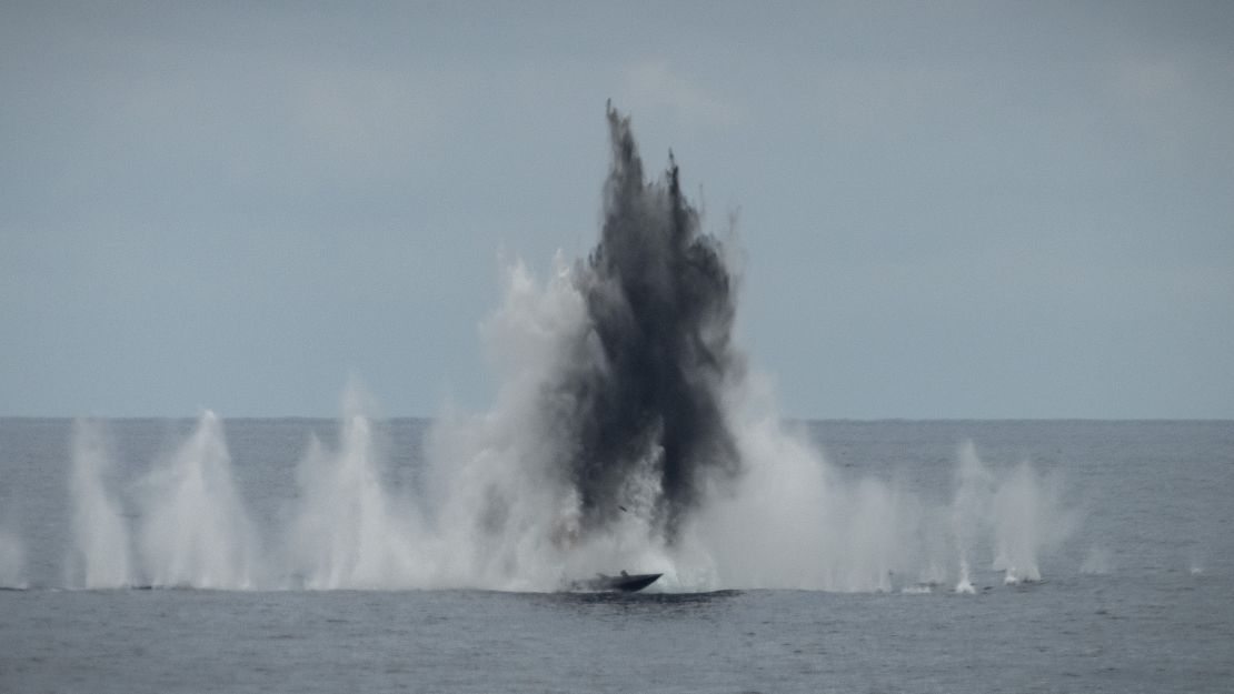 An airburst round impacts over the Hammerhead remote training target as the Canadian, Australian and US vessels conduct a live fire exercise in the South China Sea on 26 October 2023.