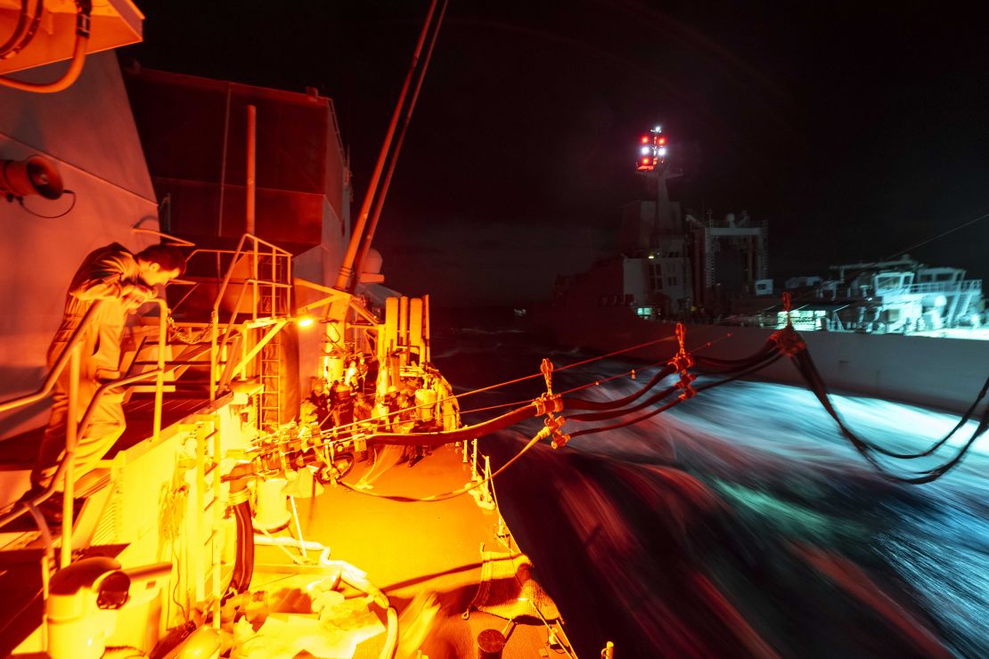 HMCS Ottawa and HMAS Stalwart conduct a Replenishment-At-Sea (RAS) at night as the ships transit the East China Sea during Indo-Pacific Deployment on 2 November 2023.