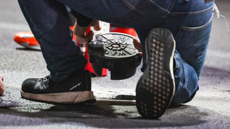 LAS VEGAS, NEVADA - NOVEMBER 16: Course staff attempt to fix the broken manhole cover during practice ahead of the F1 Grand Prix of Las Vegas at Las Vegas Strip Circuit on November 16, 2023 in Las Vegas, United States. (Photo by Kym Illman/Getty Images)