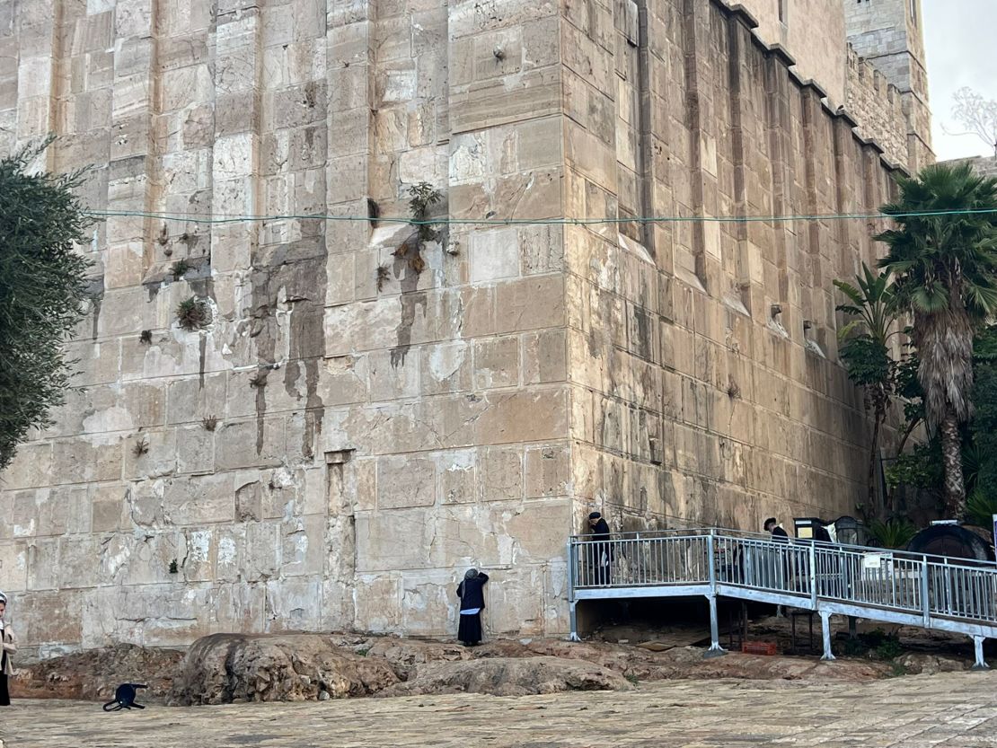 People pray on the exterior wall of the Cave of the Patriarchs on November 17 in Hebron, West Bank.