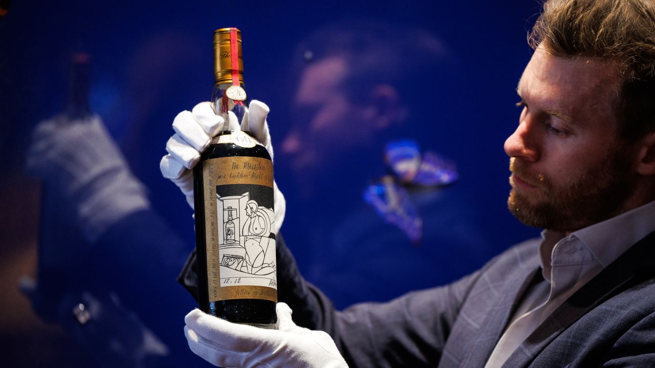 Jonny Fowle, Sotheby's Global Head of Spirits, unveils a bottle of The Macallan 1926, the world's most expensive whisky estimated at £750,000- 1,200,000, at Sotheby's on October 19, 2023 in London, England. After being aged in sherry casks for six decades, just 40 bottles of The Mcallan 1926 were bottled in 1986. The Mcallan Adami 1926 is one of 12 bottles in the series with a label designed by Italian artist Valerio Adami and is the first bottle to have undergone reconditioning by The Mcallan Distillery ahead of being presented at auction at Sotheby's in London on November 18, 2023.