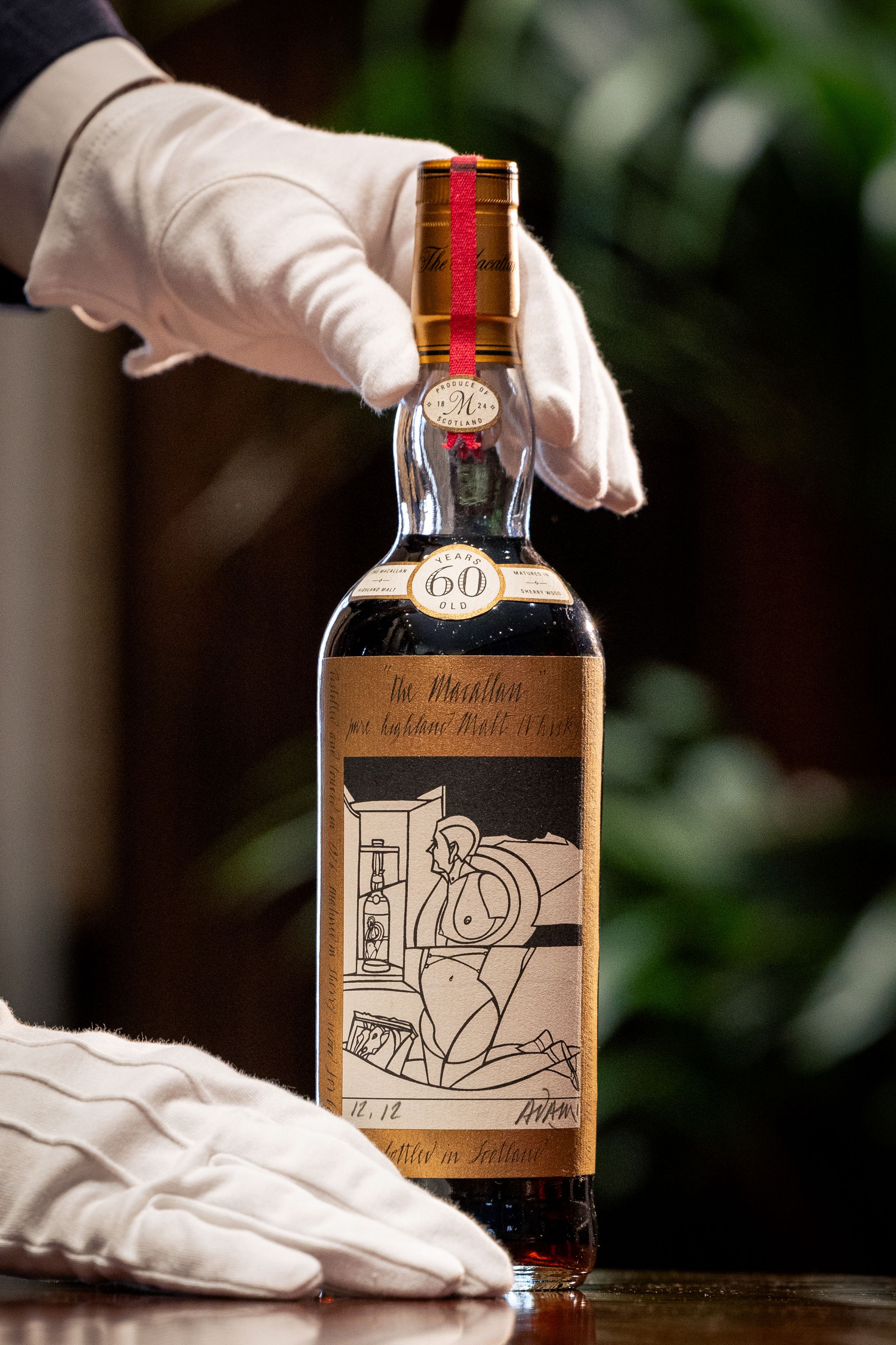 A bottle of The Macallan 1926, the world's most expensive whisky estimated at £750,000- 1,200,000, is unveiled at Sotheby's on October 19, 2023 in London, England. After being aged in sherry casks for six decades, just 40 bottles of The Mcallan 1926 were bottled in 1986. The Mcallan Adami 1926 is one of 12 bottles in the series with a label designed by Italian artist Valerio Adami and is the first bottle to have undergone reconditioning by The Mcallan Distillery ahead of being presented at auction at Sotheby's in London on November 18, 2023.