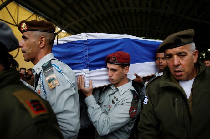 Israeli soldiers carry the casket of Major Jamal Abbas, an Israeli soldier from Israel's Druze minority who was killed in Gaza amid Israel's ongoing ground operation, at his funeral in Pekiin, Israel, on November 19.