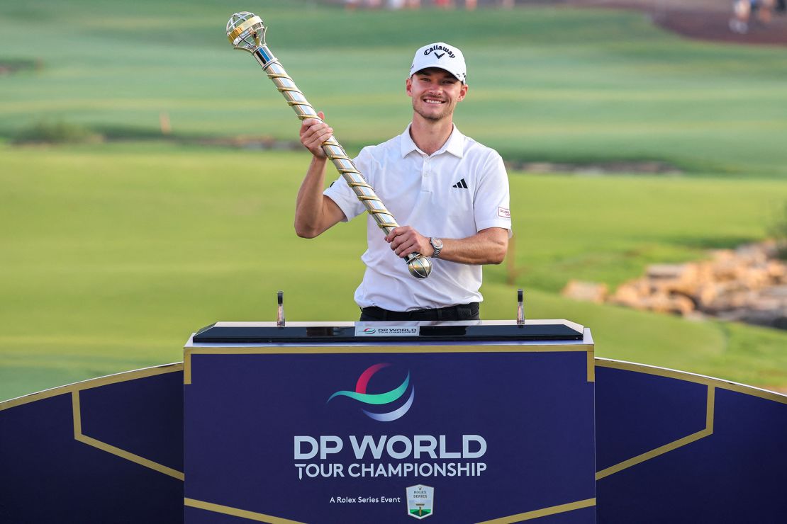 Denmark's Nicolai Hojgaard raises the winner's trophy after the last day of the DP World Tour Championship European Tour golf tournament 2023 at Jumeirah Golf Estates in Dubai on November 19, 2023. (Photo by Giuseppe CACACE / AFP) (Photo by GIUSEPPE CACACE/AFP via Getty Images)