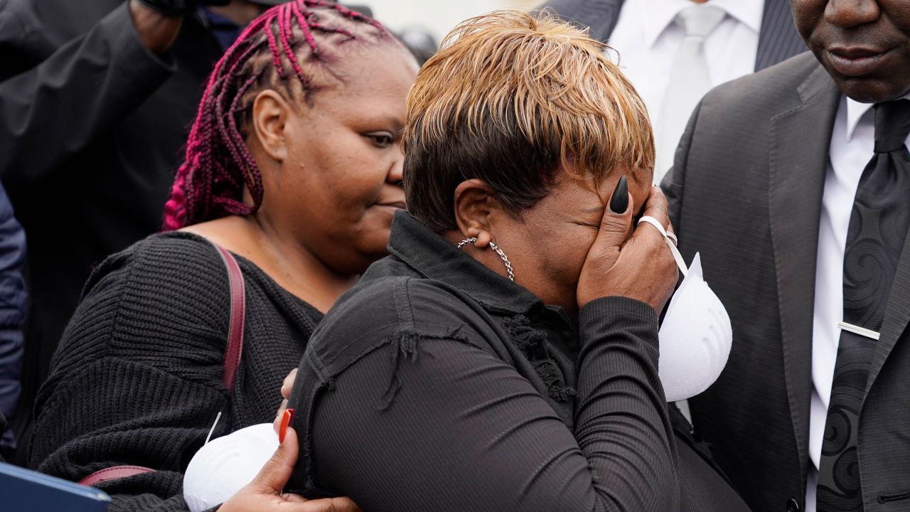 Bettersten Wade, mother of Dexter Wade, a 37-year-old man who died after being hit by a Jackson, Miss., police SUV driven by an off-duty officer, is comforted by her daughter, Latonya Moore, left, while watching her son's body transferred to a mortuary transport, after being exhumed from a pauper's cemetery near the Hinds County Penal Farm in Raymond, Monday, Nov. 13, 2023. Civil rights attorney Ben Crump said Monday he is asking the U.S. Justice Department to investigate why authorities waited several months to notify the family of his death. (AP Photo/Rogelio V. Solis)