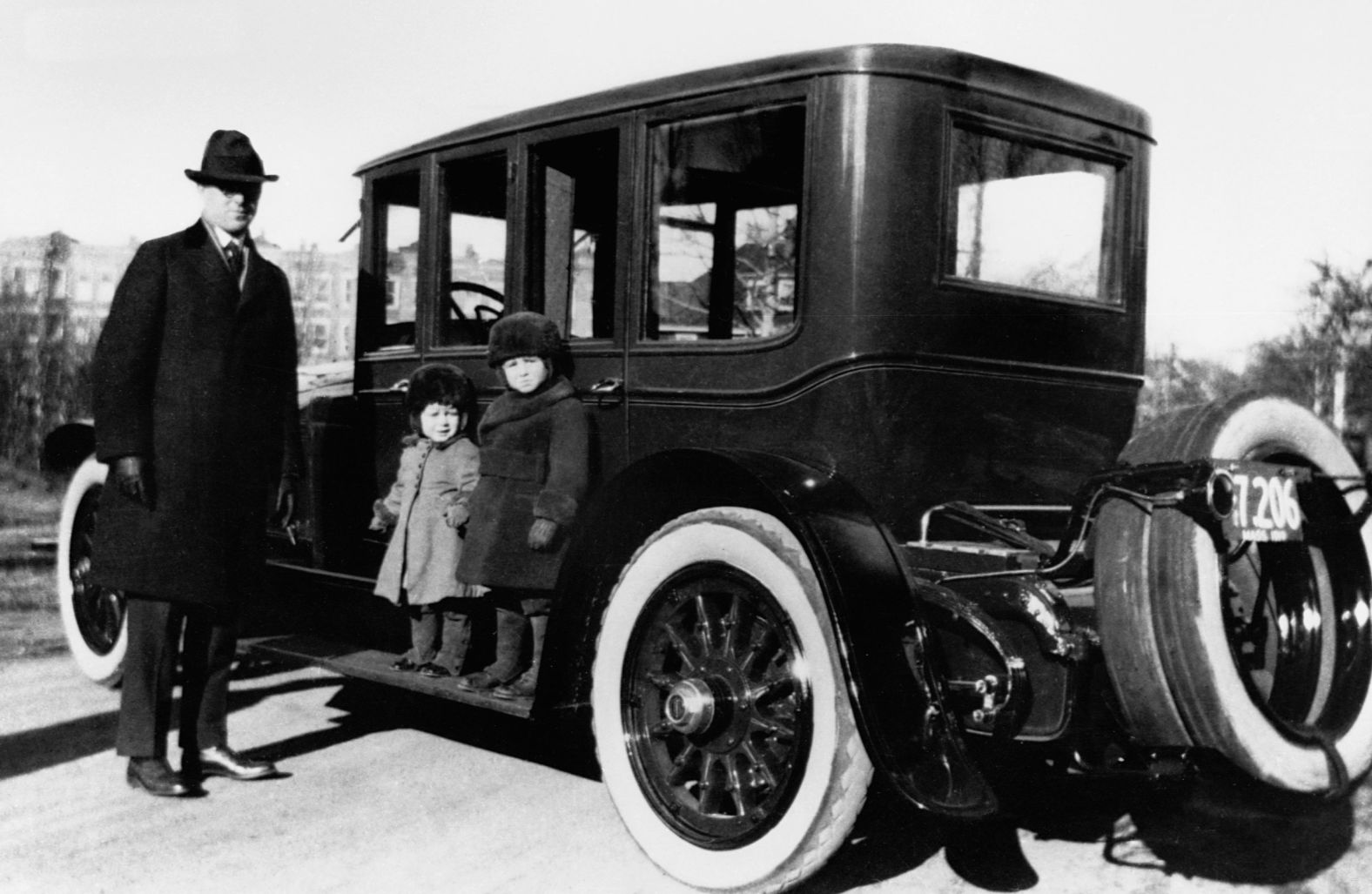 John F. Kennedy, center, poses with his older brother, Joseph P. Kennedy Jr., and his father, Joseph P. Kennedy Sr., in Brookline, Massachusetts, in 1919.