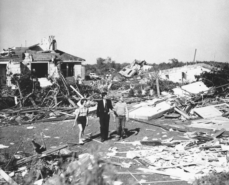 Kennedy, accompanied by teenagers Dick and Melissa Mayer, inspects tornado damage in Shrewsbury, Massachusetts, in June 1953.