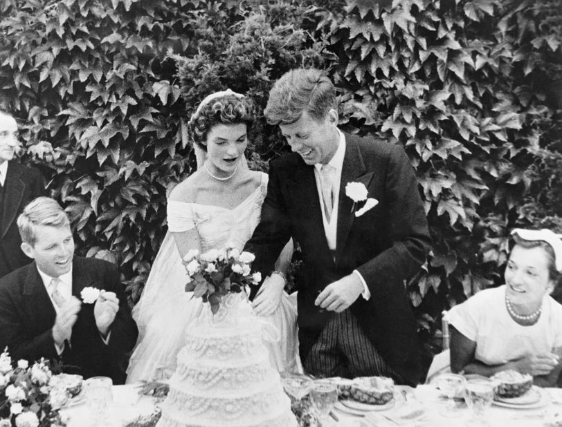 The Kennedys cut into their wedding cake after being married in Newport, Rhode Island, in September 1953.