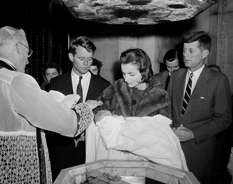 Kennedy watches as his 15-day-old daughter, Caroline, is christened in New York in December 1957.