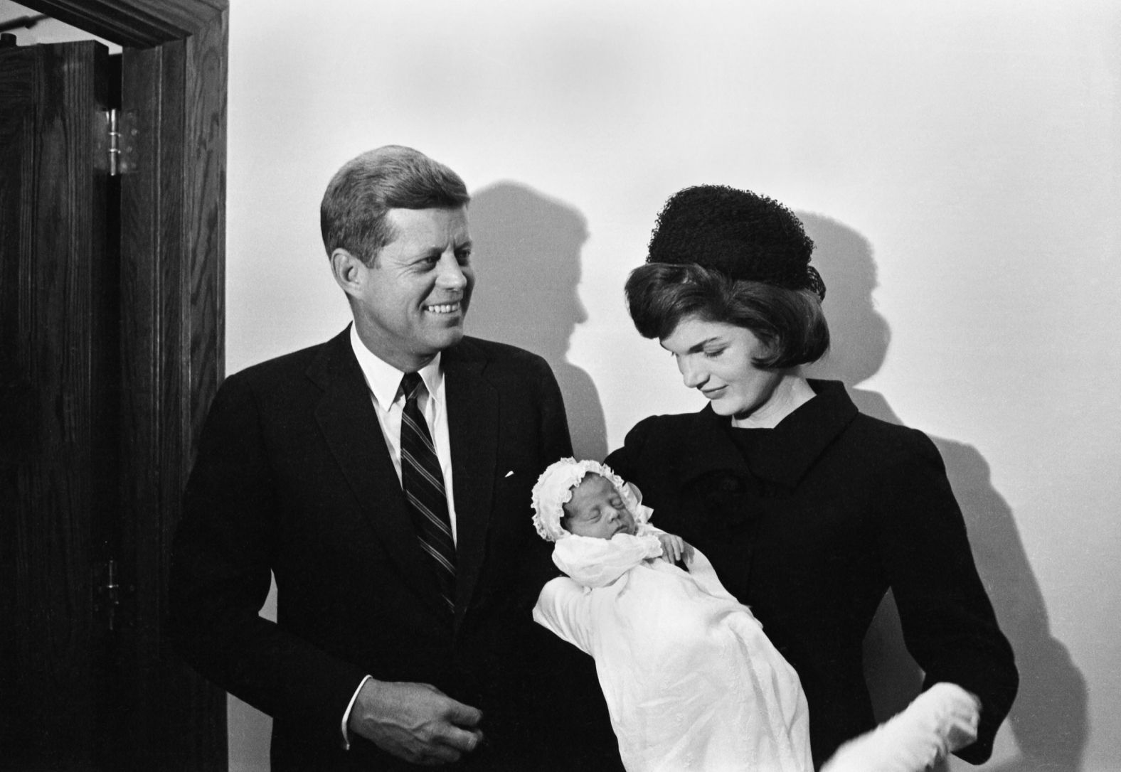 Kennedy stands with his wife, Jacqueline, and his newborn son, John Jr., during the baby's christening in December 1960.