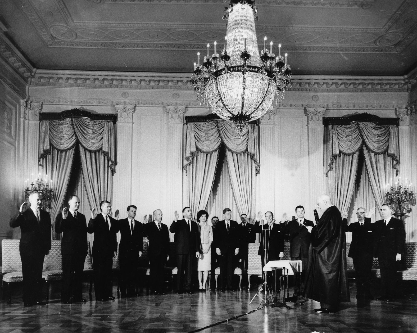 Kennedy's Cabinet is sworn in by Supreme Court Chief Justice Earl Warren in the East Room of the White House in January 1961. 