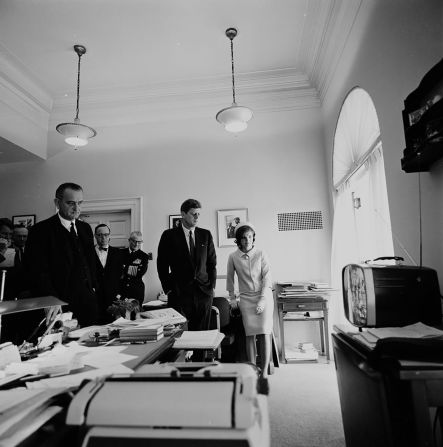 Kennedy watches television in his secretary's office as astronaut Alan Shepard lifts off to become the first American in space in May 1961.