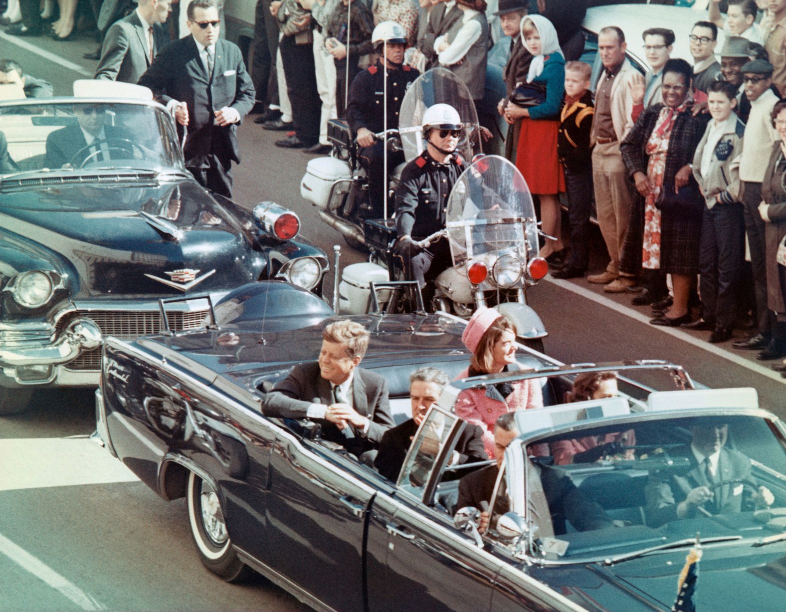 The Kennedys ride in the back seat of a limousine as the president's motorcade drives toward Dealey Plaza in Dallas on November 22, 1963. He was shot minutes later by Lee Harvey Oswald.