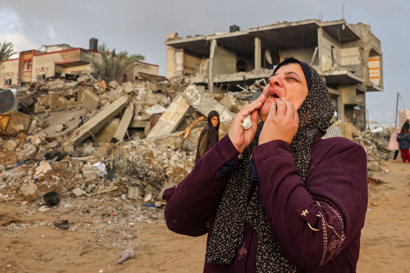 A Palestinian woman cries in anguish following Israeli strikes on Rafah, Gaza on November 20.