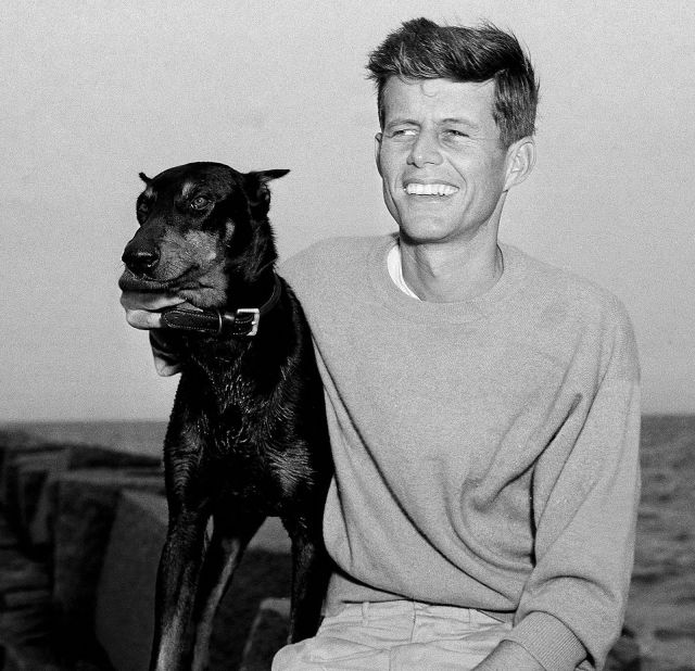 Kennedy relaxes with his dog Mo in Hyannis Port, Massachusetts, in June 1946.