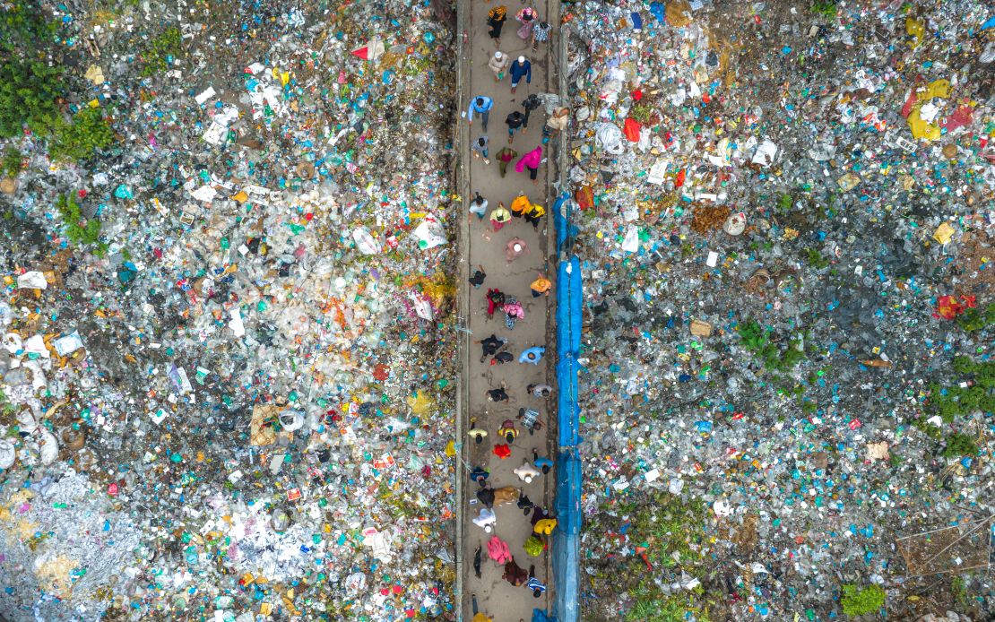 A bridge in Dhaka, Bangladesh, is surrounded by plastic waste.