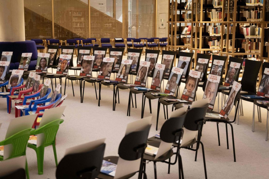 A picture taken on November 21, 2023 at the new building of the National Library of Israel in Jerusalem, shows an installation consisting of chairs with books and portraits of Israeli hostages taken by Palestinian Hamas militants during the October 7 attack. (Photo by Kenzo TRIBOUILLARD / AFP) (Photo by KENZO TRIBOUILLARD/AFP via Getty Images)