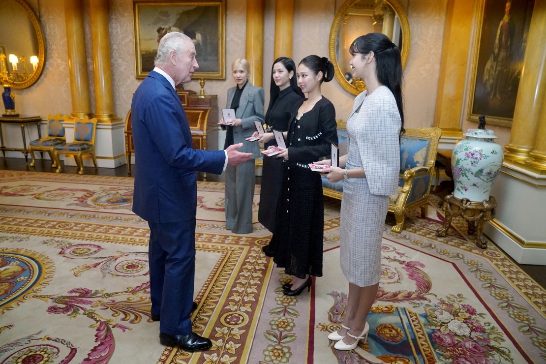 King Charles III presents the members of the K-Pop band Blackpink, (left to right) Rose (Roseanne Park), Jisoo Kim, Jennie Kim, and Lisa (Lalisa Manoban), with Honorary MBEs (MBE (Member of the Order of the British Empire) during a special investiture ceremony in the presence of the President of South Korea, Yoon Suk Yeol, and his wife, Kim Keon Hee at Buckingham Palace, on November 22, 2023 in London, England.
