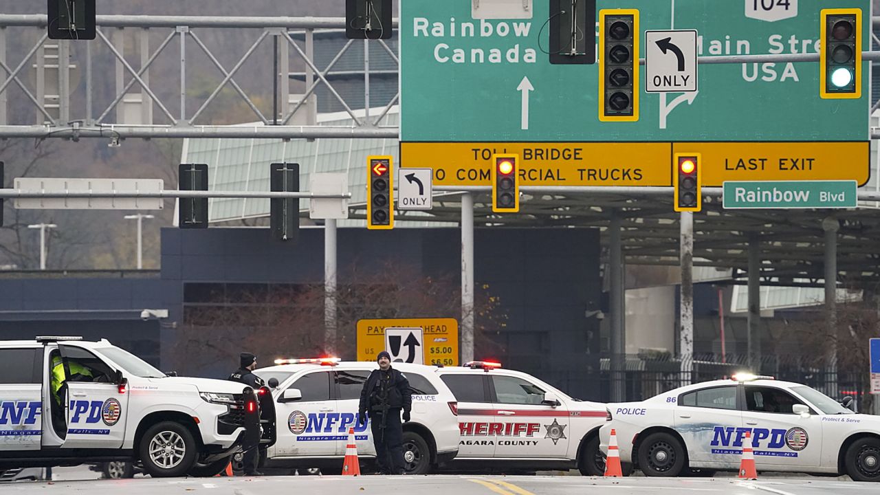 Law enforcement personnel block off the entrance to the Rainbow Bridge, Wednesday, Nov. 22, 2023, in Niagara Falls, N.Y. The border crossing between the U.S. and Canada has been closed after a vehicle exploded at a checkpoint on a bridge near Niagara Falls. The FBI's field office in Buffalo said in a statement that it was investigating the explosion on the Rainbow Bridge, which connects the two countries across the Niagara River. (Derek Gee/The Buffalo News via AP)