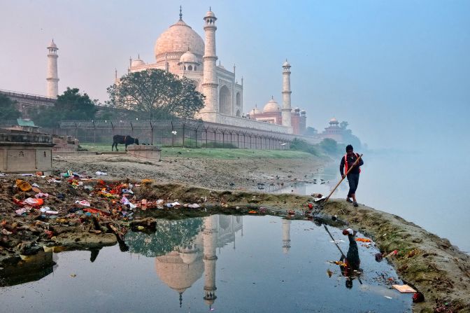 In a photo by Hoang Long Ly, a worker cleans up the environment behind the Taj Mahal in India.