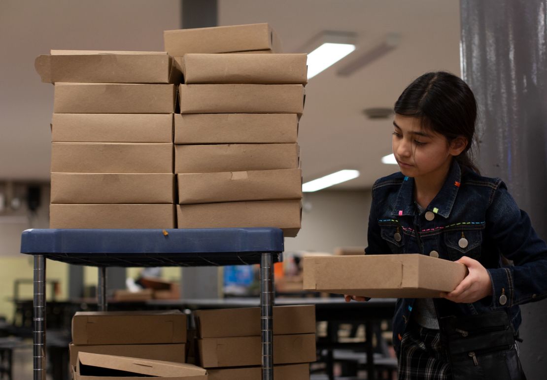 Safa Faqiry helps stack baked pies for the homeless at Robert F. Wagner Middle School in New York City, on November 18.