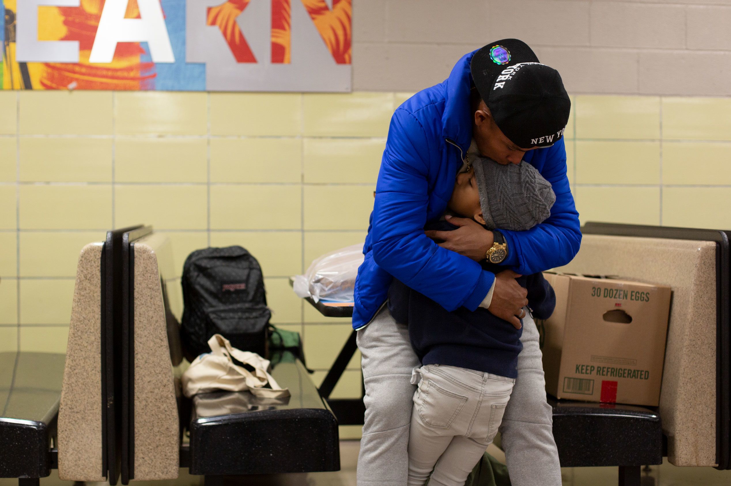 Franklin Jose Rivero comforts his stepson Jean Luis Hernandez at Robert F. Wagner Middle School in New York City, on November 18.