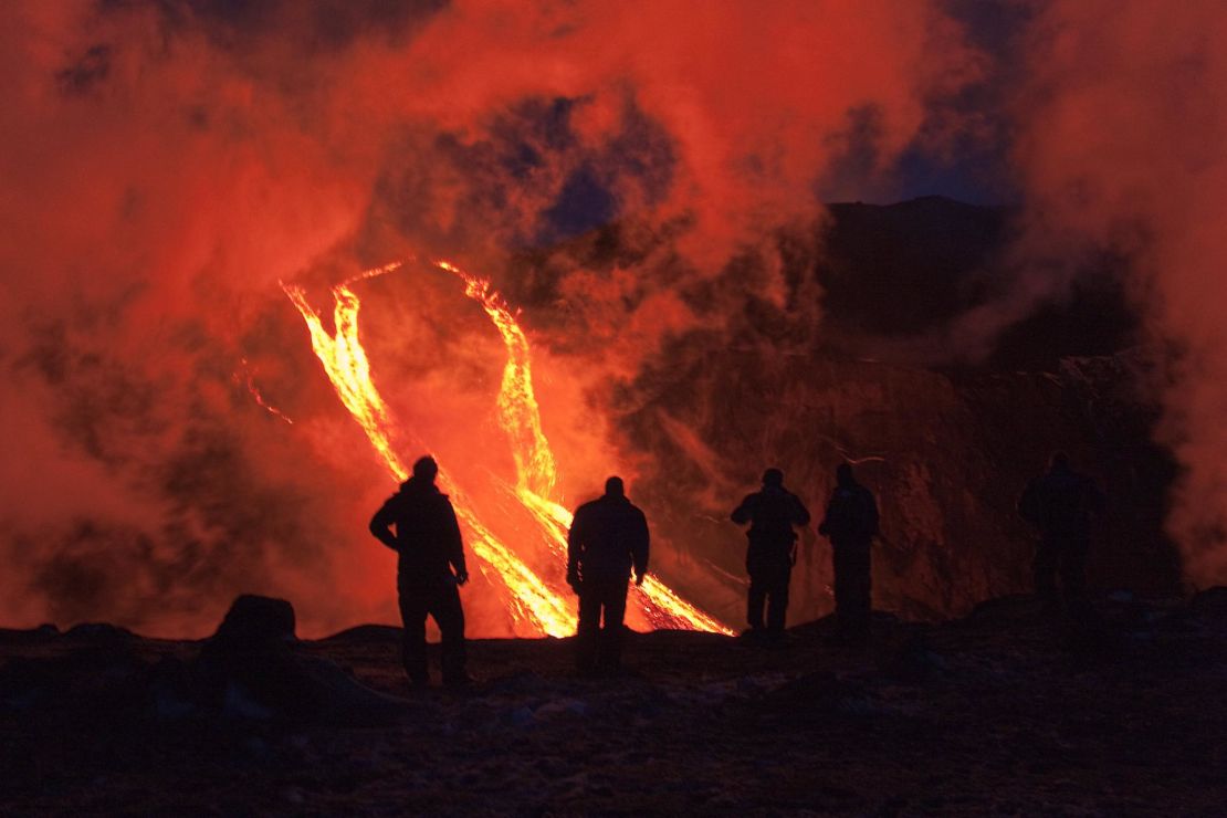 FIMMVORDUHALS, ICELAND - MARCH 24:  Hikers are silhouetted against rivers of lava flowing from a volcanic eruption between the Myrdalsjokull and Eyjafjallajokull glaciers on March 24, 2010 in Fimmvorduhals, Iceland. A major eruption occured on April 14, 2010 which has resulted in a plume of volcanic ash being thrown into the atmosphere over parts of Northen Europe. Air traffic has been subject to cancellation or delay as airspace across parts of Northern Europe has been closed.  (Photo by Helen Maria Bjornsd/NordicPhotos/Getty Images)