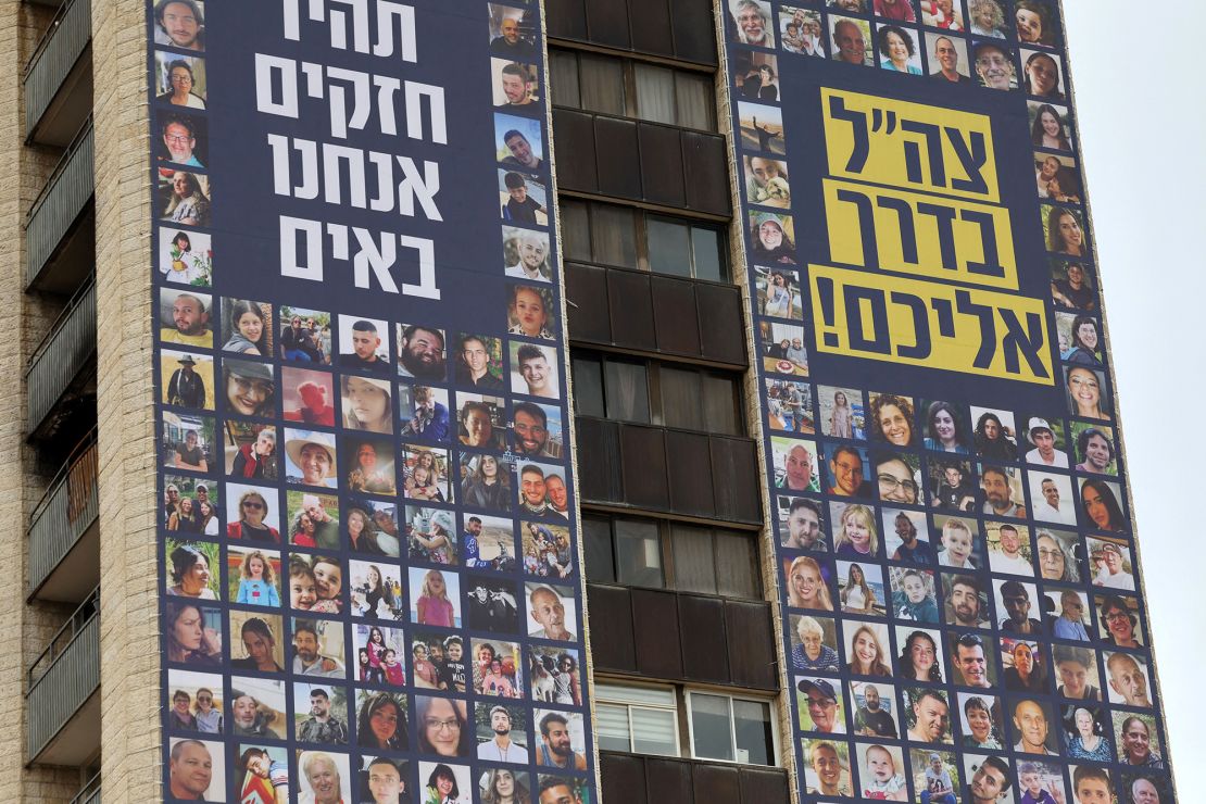 A picture taken on November 22, 2023, shows a billboard bearing the portraits of Israeli hostages taken by Palestinian militants in the October 7 attack, and calling for their release in Jerusalem. (Photo by AHMAD GHARABLI / AFP) (Photo by AHMAD GHARABLI/AFP via Getty Images)