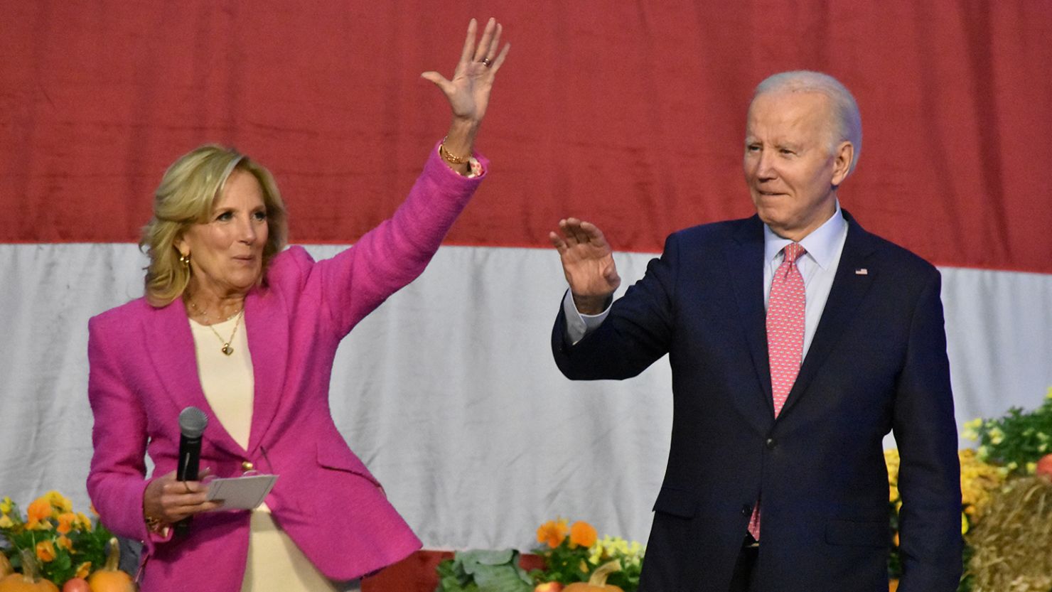 First Lady Jill Biden (L) and President Joe Biden (R) wave to service-members and their families at Norfolk Naval Station in Norfolk, Virginia, United States on November 19, 2023.