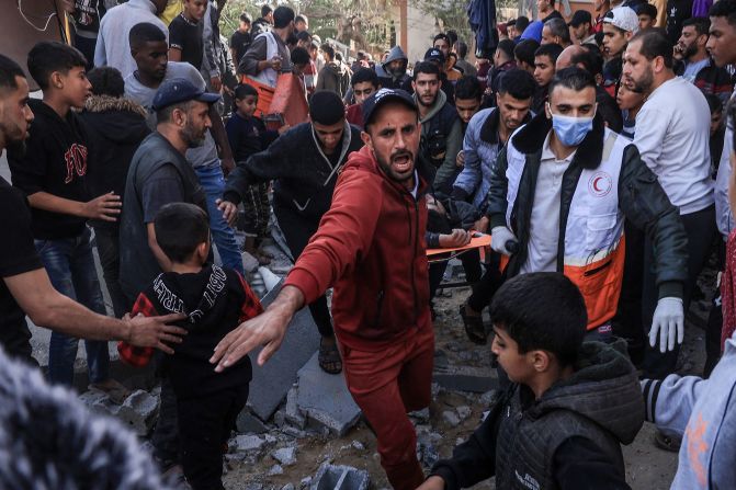 A Palestinian medic and civilians carry an injured man after an Israeli strike on Rafah, Gaza, on Thursday, November 23.
