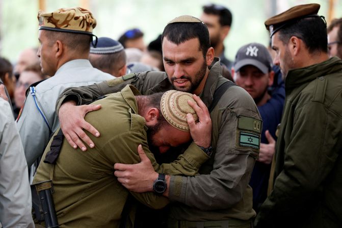 Soldiers react during the funeral of Captain Liron Snir, 25, at the Mount Herzl military cemetery in Jerusalem, on November 22.