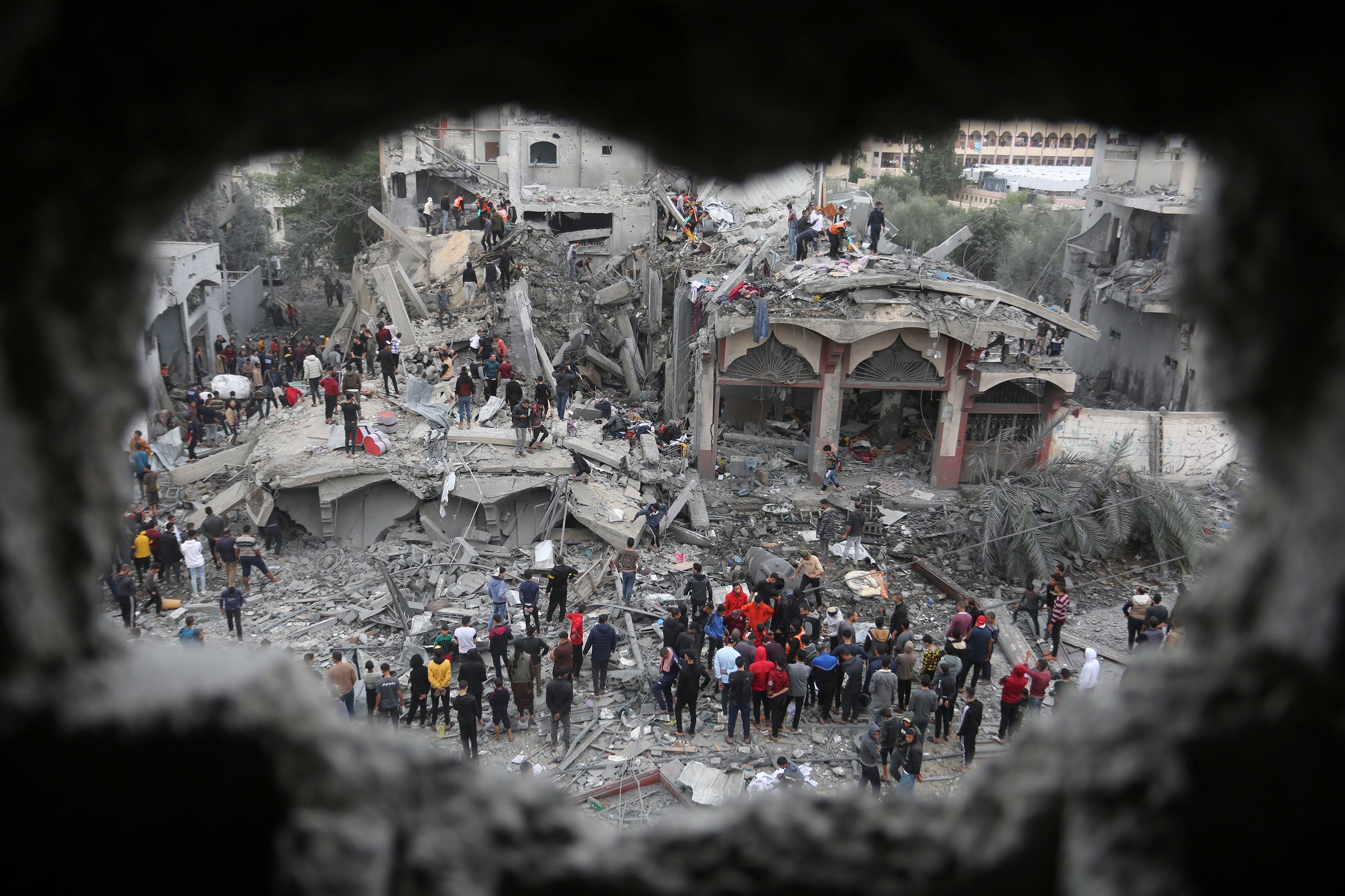 Palestinians search for survivors after an Israeli strike in Rafah, Gaza, on Wednesday, November 22.